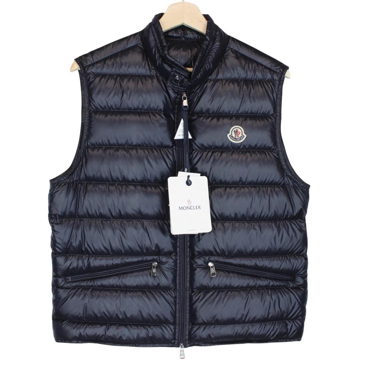 Moncler navy blue down gilet with logo patch and quilted design.