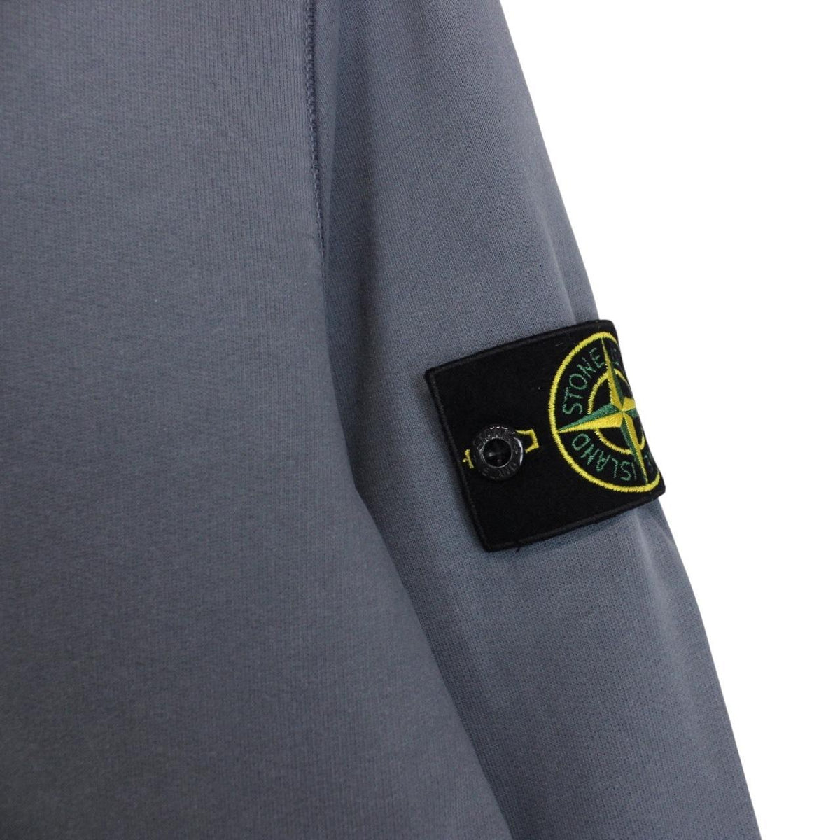 Stone Island blue cotton sweatshirt with iconic compass logo and ribbed cuffs.