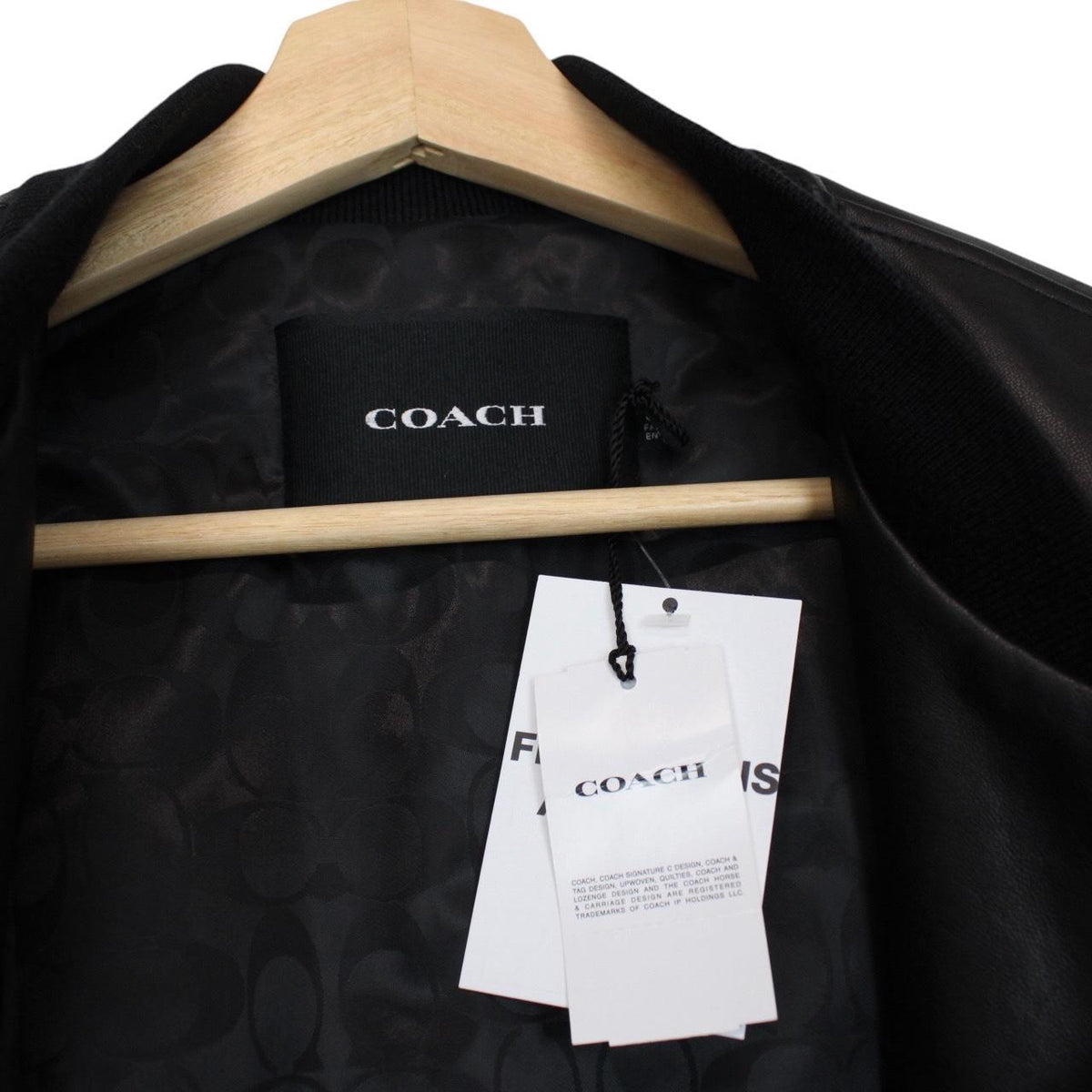 Coach black lamb leather bomber jacket with full zip and brand logo.