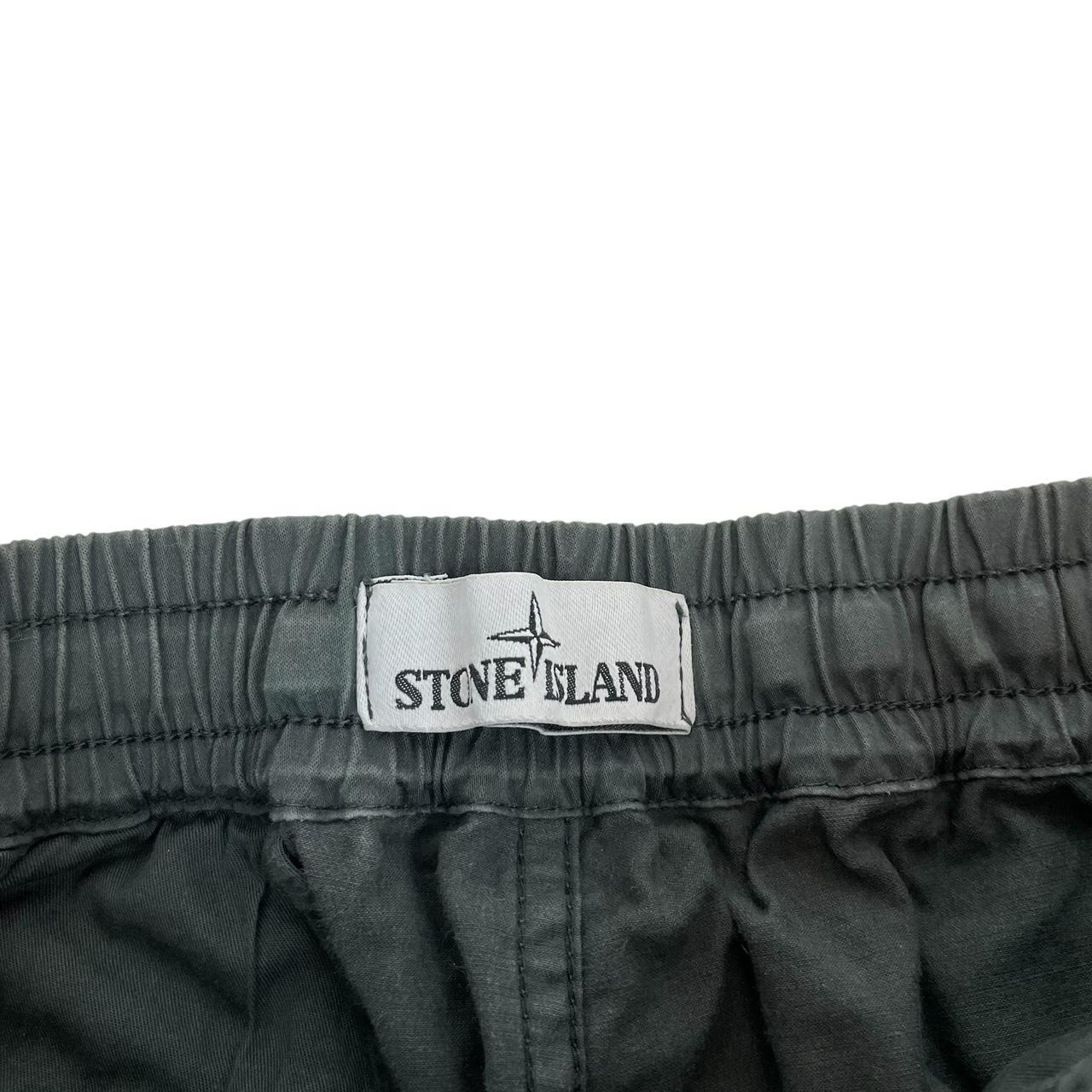 Stone Island grey cargo trousers with logo patch and pockets, visible discolouration.