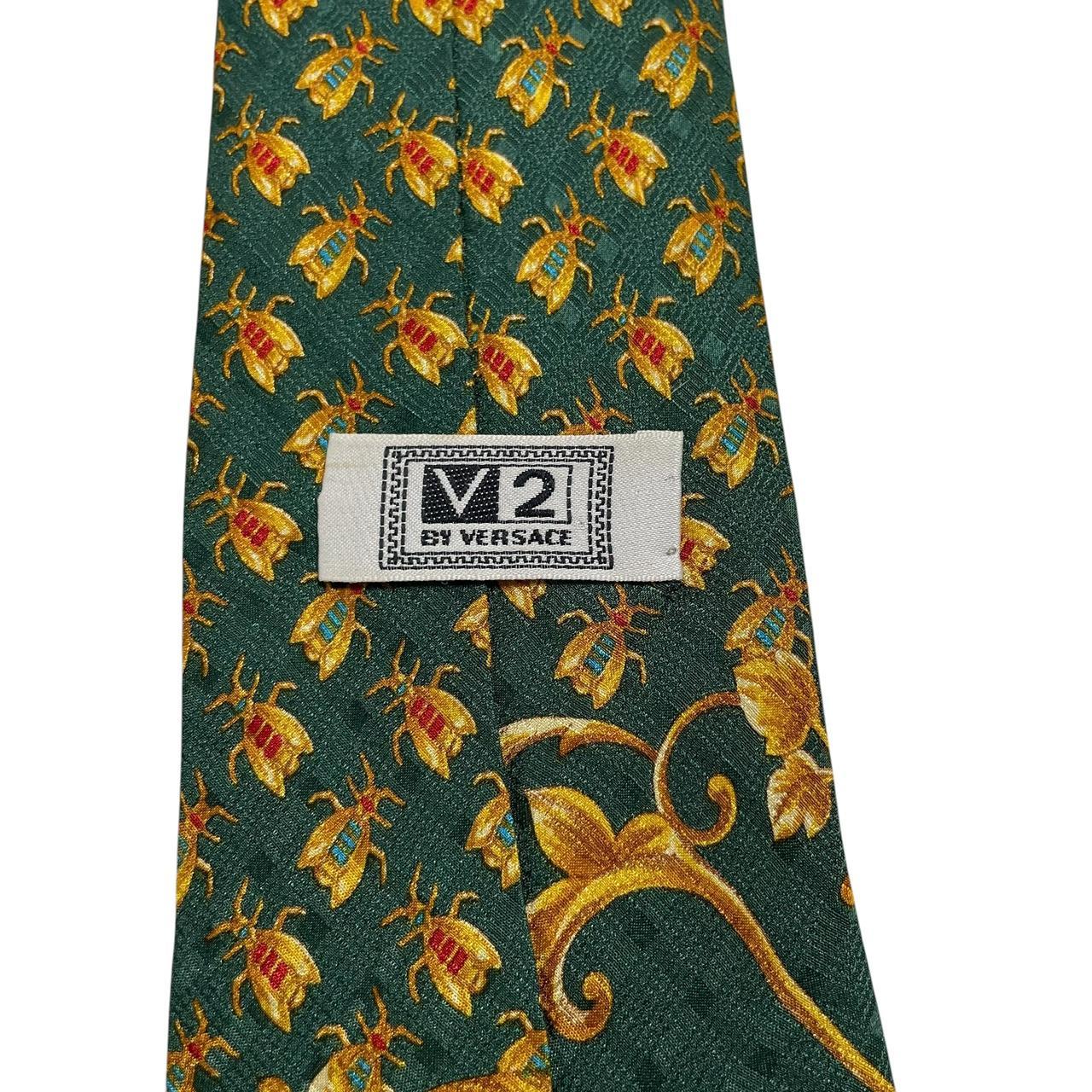 Versace silk tie green and gold baroque print with intricate design details.