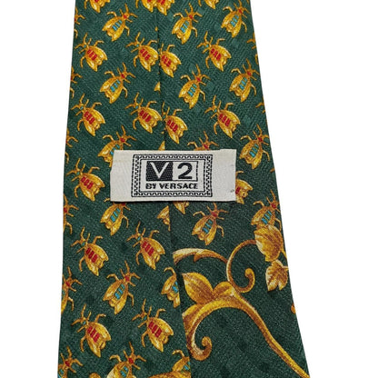 Versace silk tie green and gold baroque print with intricate design details.
