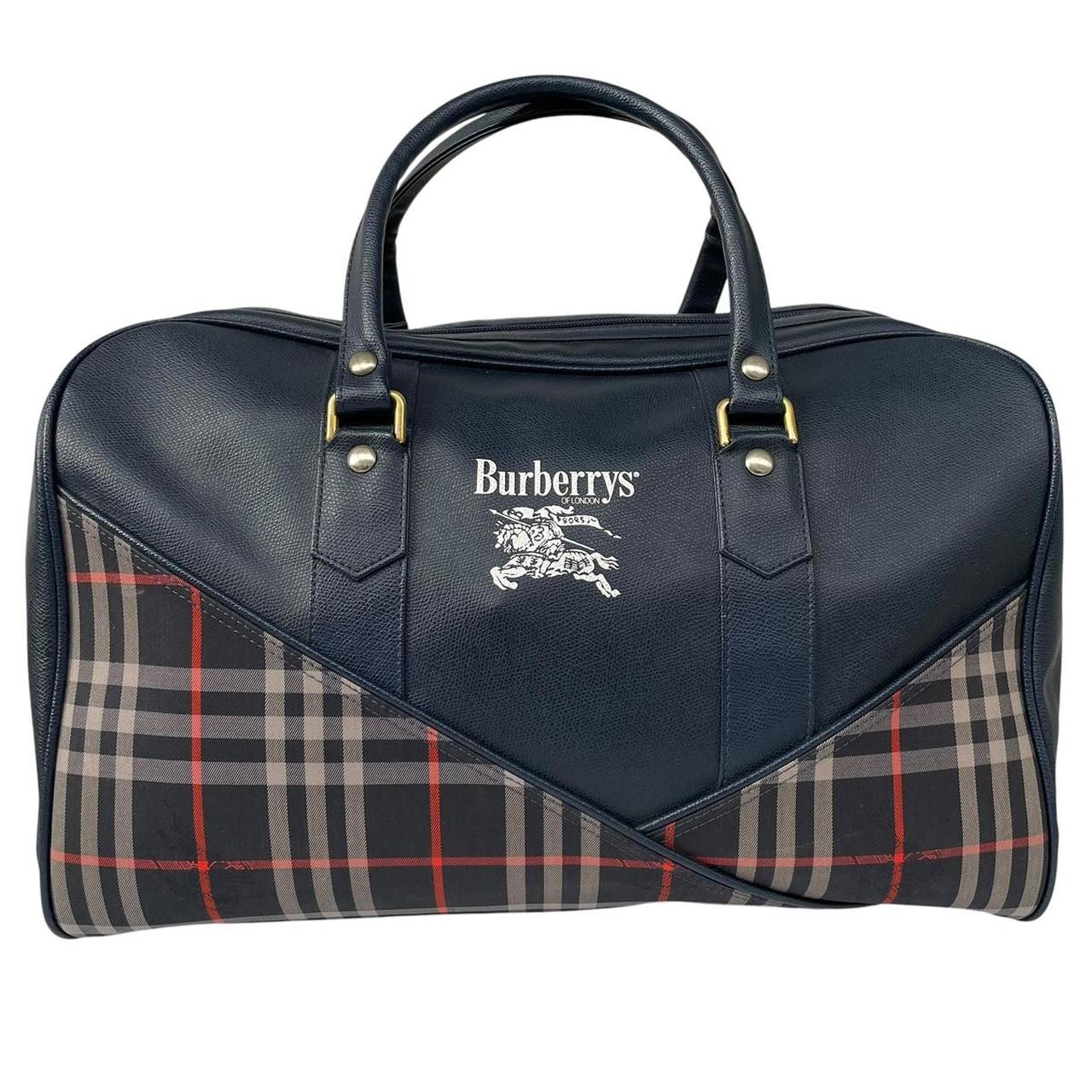 Burberry navy blue duffel bag featuring iconic Nova Check pattern and leather accents.