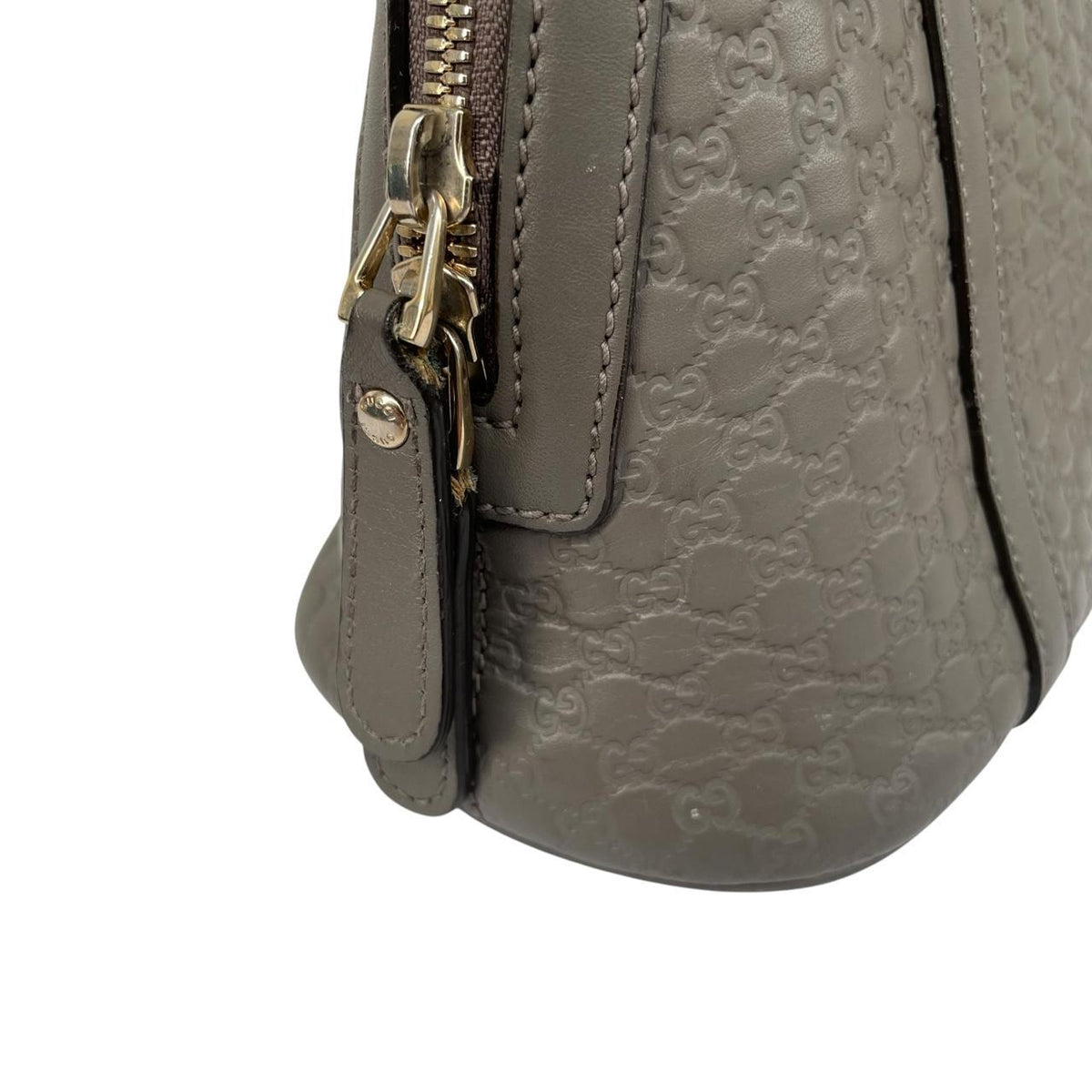 Gucci grey microguccissima mini dome shoulder bag with embossed logo and leather material.