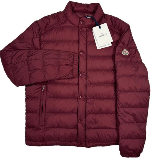 Moncler burgundy quilted down jacket with logo patch and shell material.