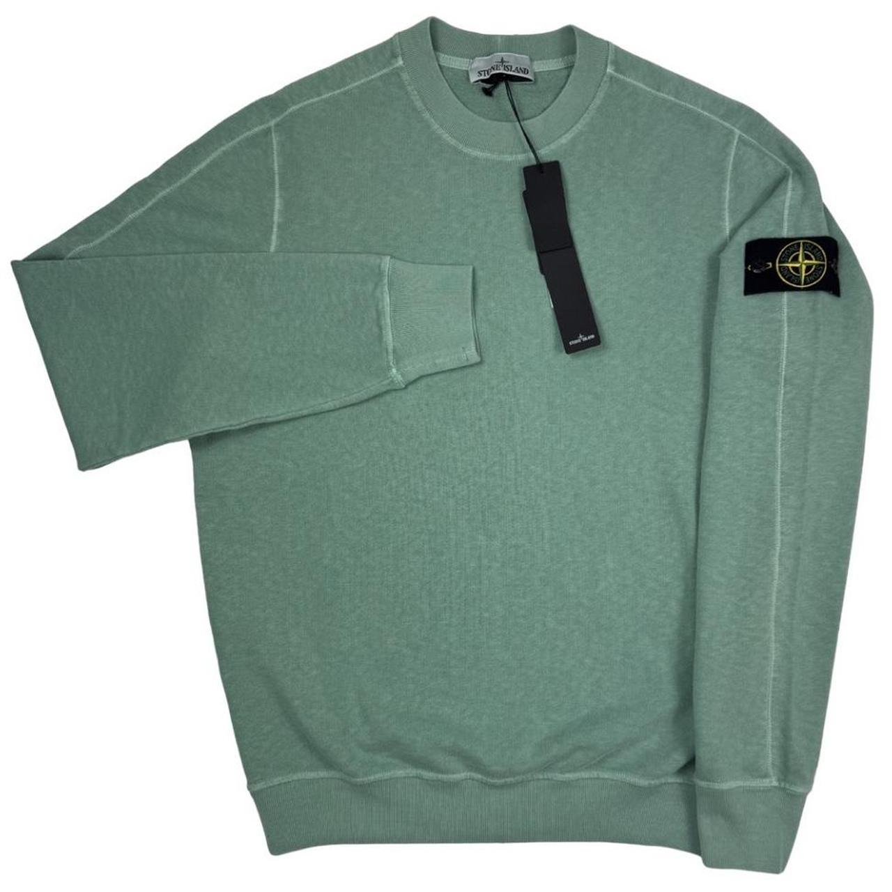Stone Island green sweatshirt with logo patch and garment dyed cotton material.