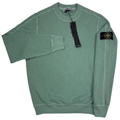 Stone Island green sweatshirt with logo patch and garment dyed cotton material.