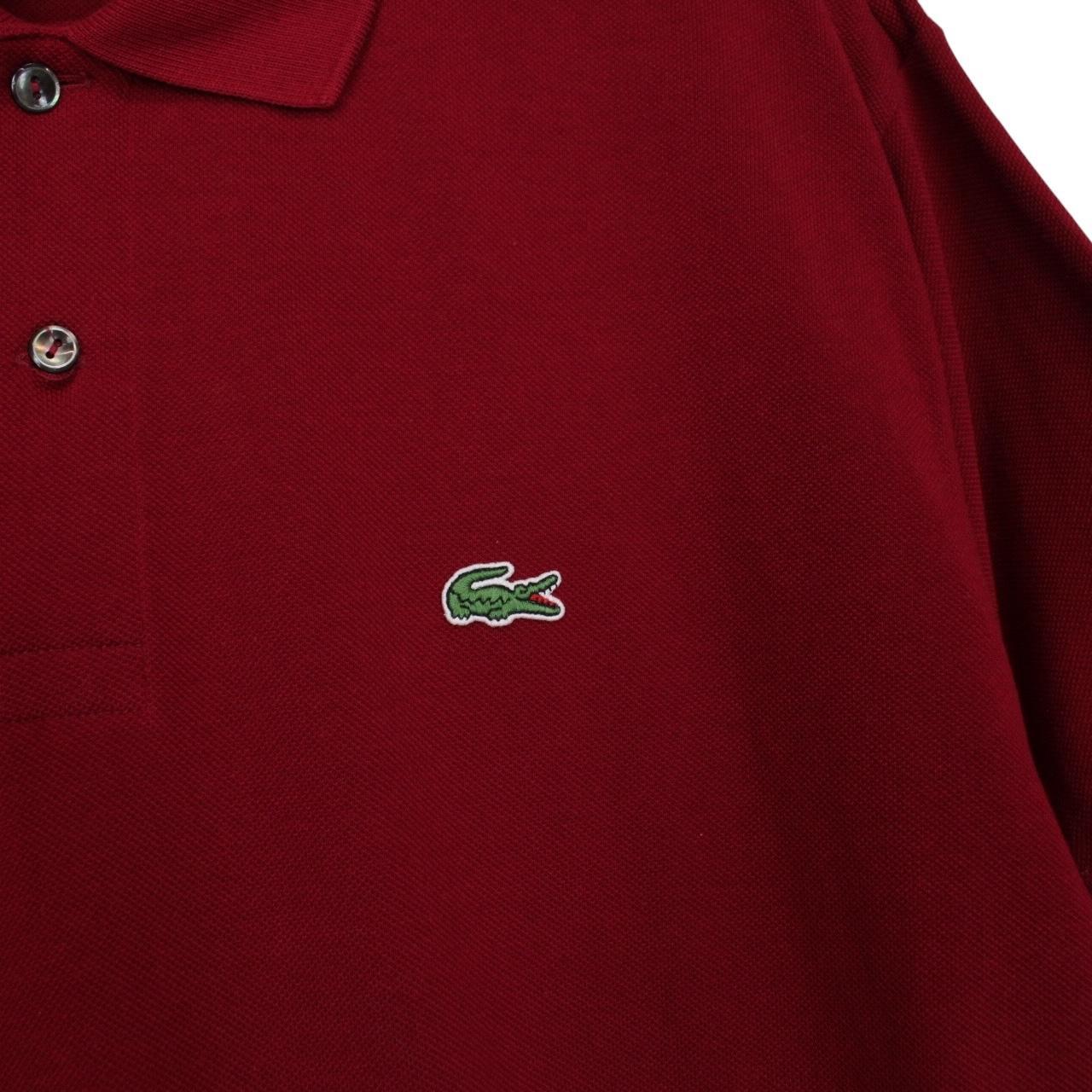 Lacoste burgundy polo shirt with embroidered crocodile logo and pocket detail.