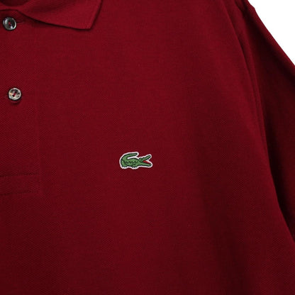 Lacoste burgundy polo shirt with embroidered crocodile logo and pocket detail.