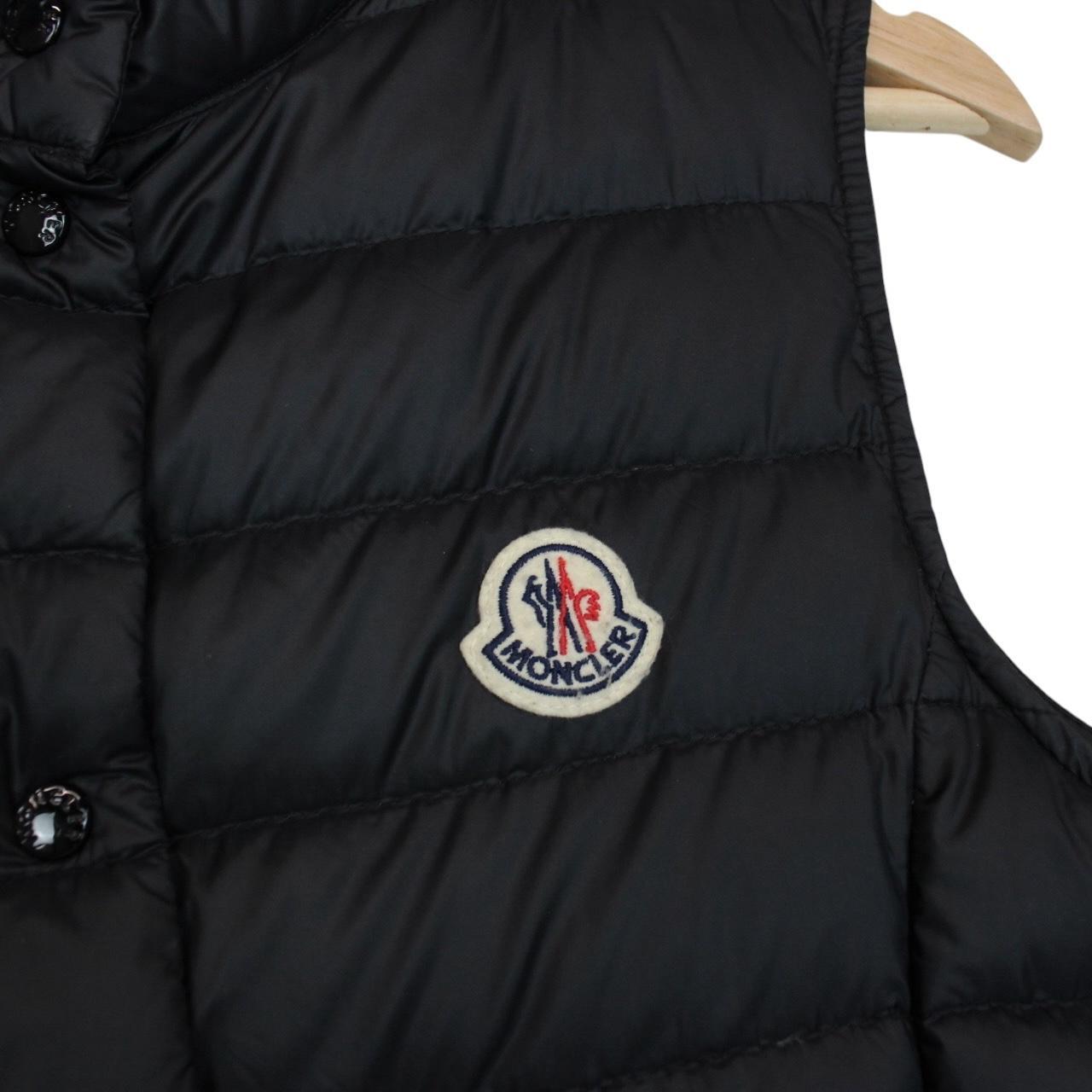 Moncler black quilted shell down gilet with logo patch and zip pockets.