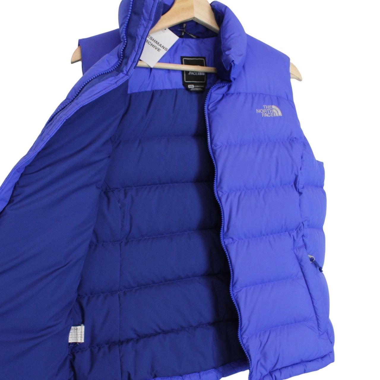The North Face blue down gilet with logo detail and quilted pattern.