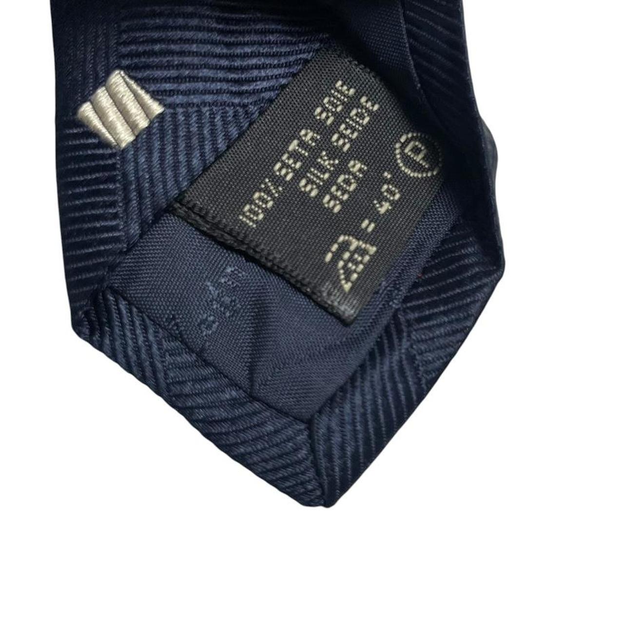 Ermenegildo Zegna navy blue silk tie with subtle sheen and elegant texture.