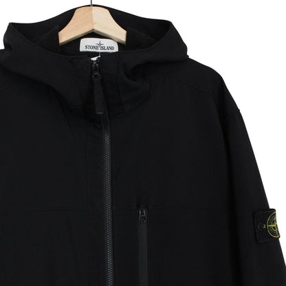 Stone Island black soft shell jacket with full zip and iconic compass logo.