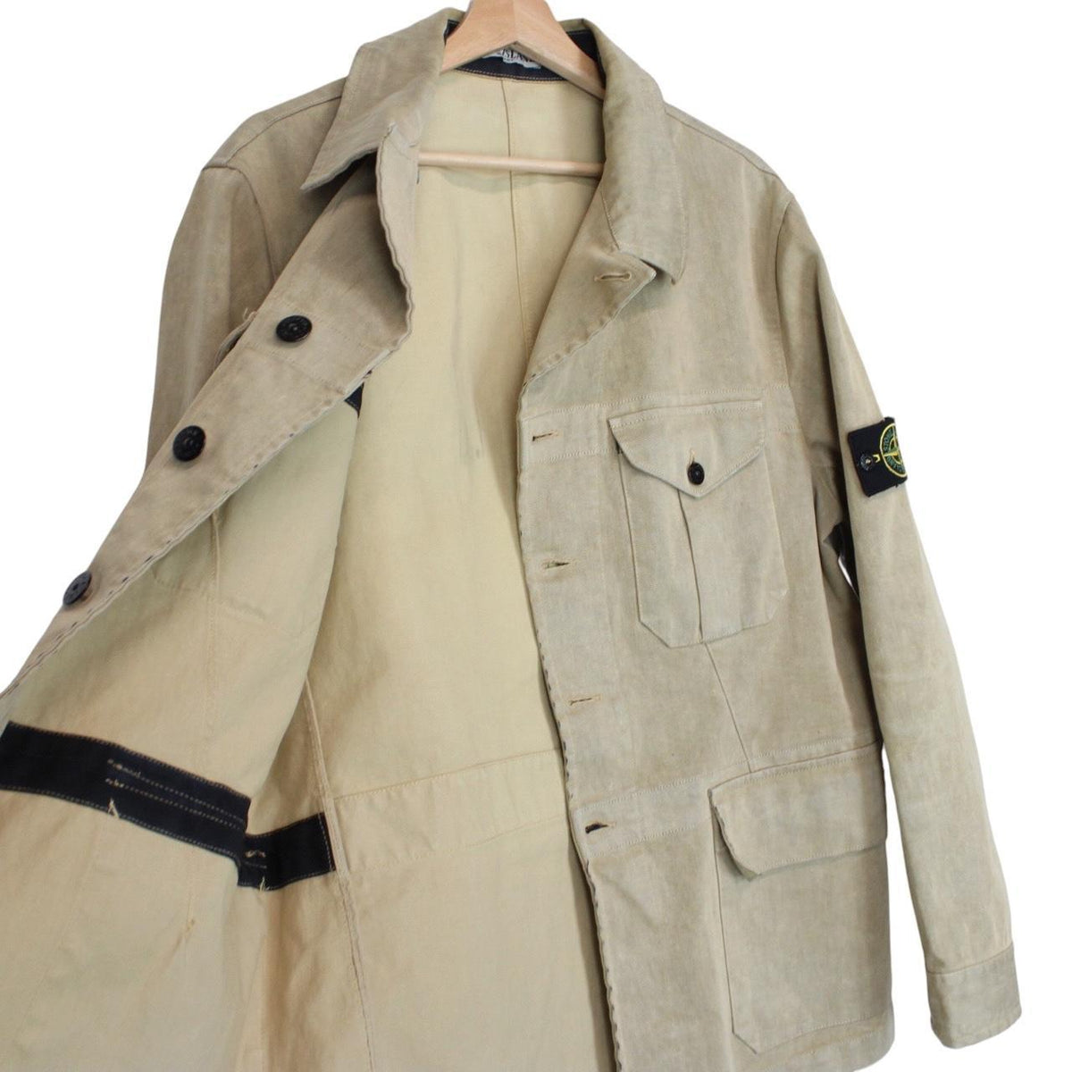 Stone Island beige multi-pocket jacket with logo patch and linen material.