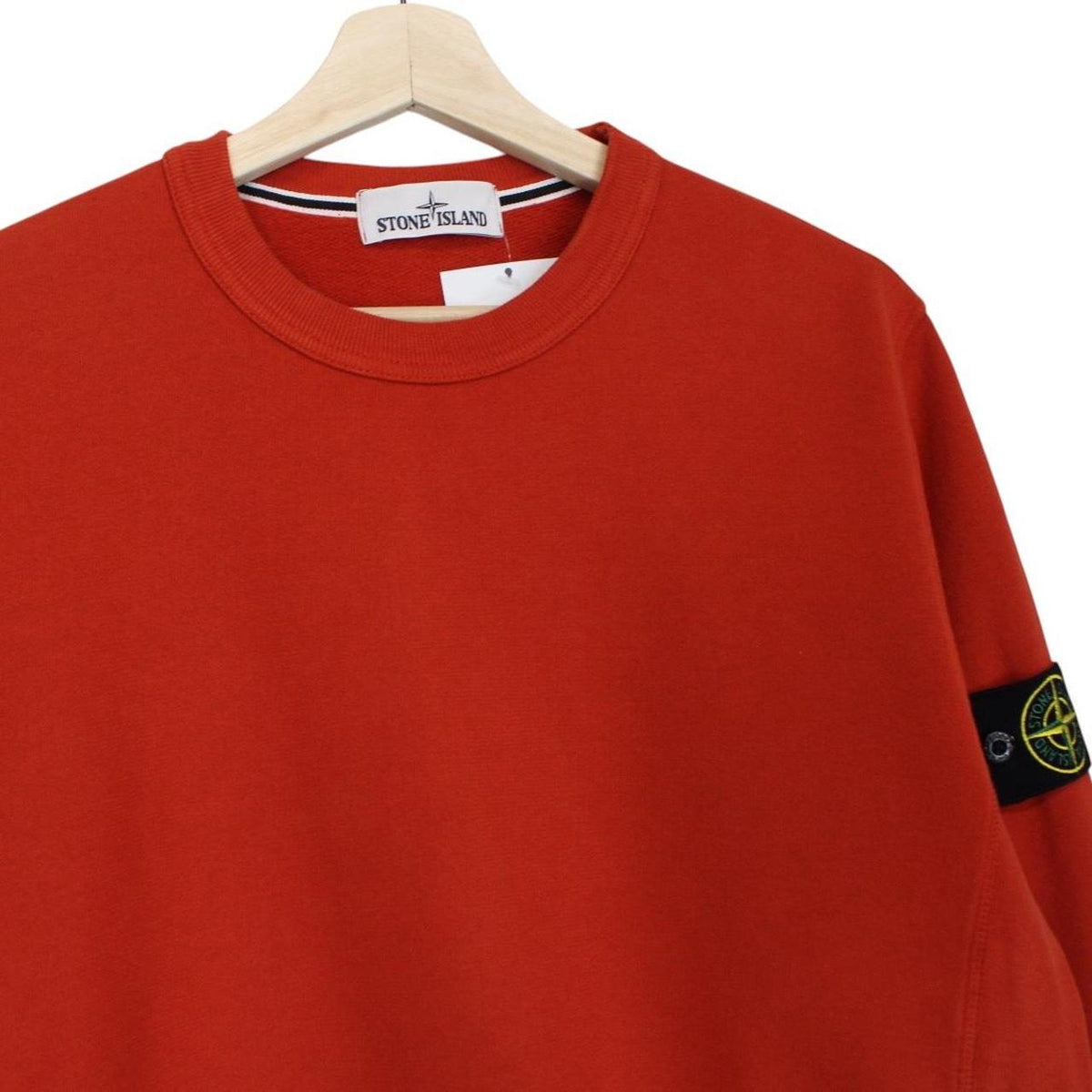 Stone Island red cotton sweatshirt with embroidered logo and ribbed cuffs.