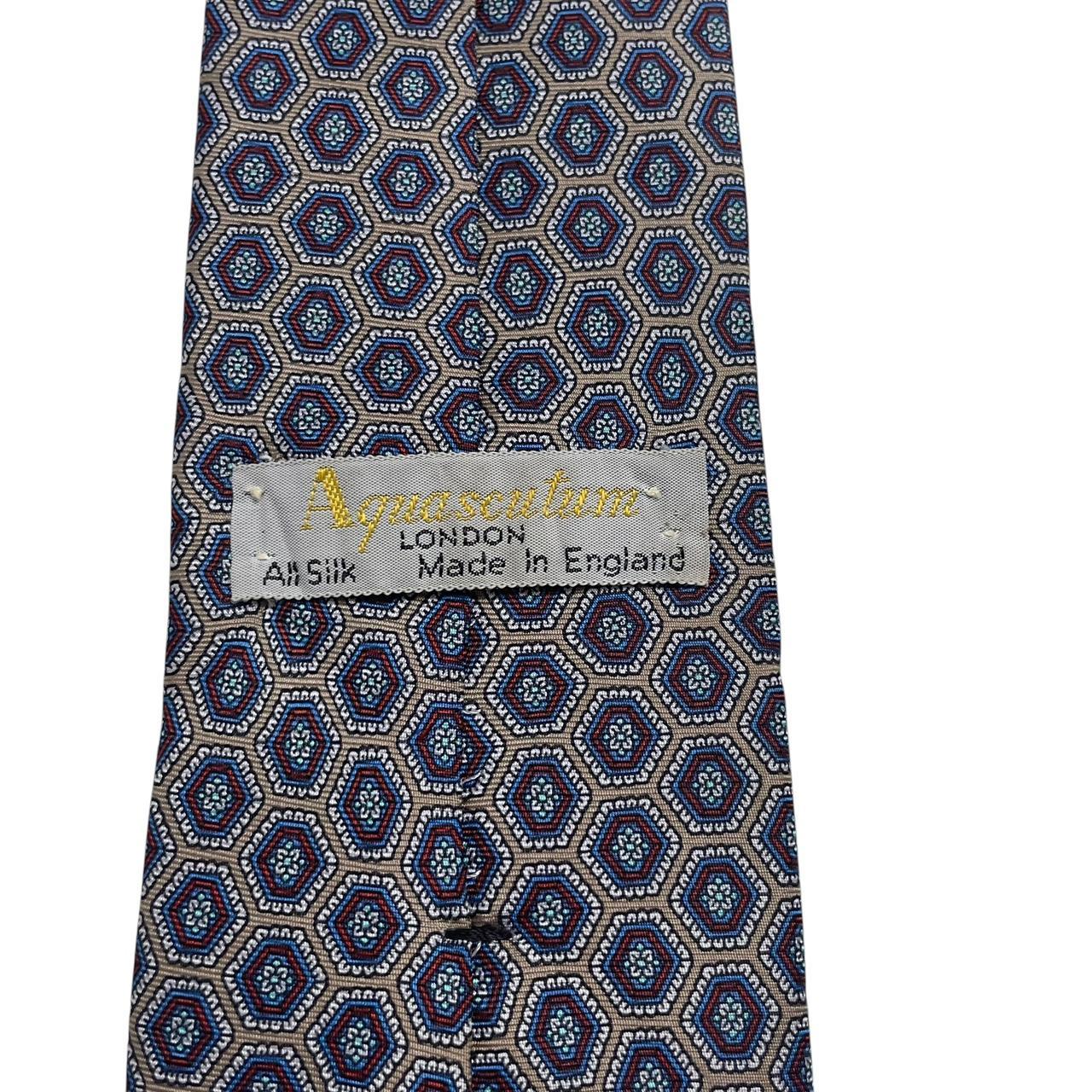 Aquascutum blue and grey silk tie with geometric print pattern.