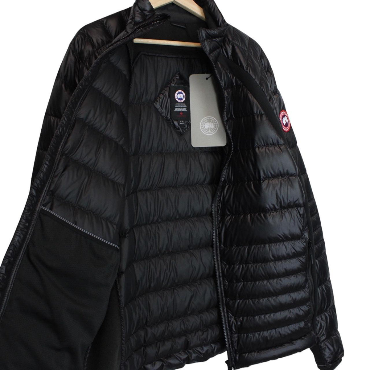 Canada Goose black down jacket with full zip and logo patch on sleeve.