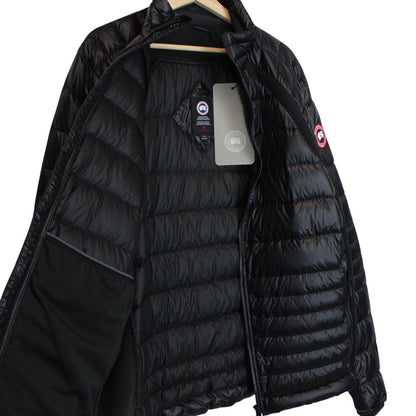 Canada Goose black down jacket with full zip and logo patch on sleeve.