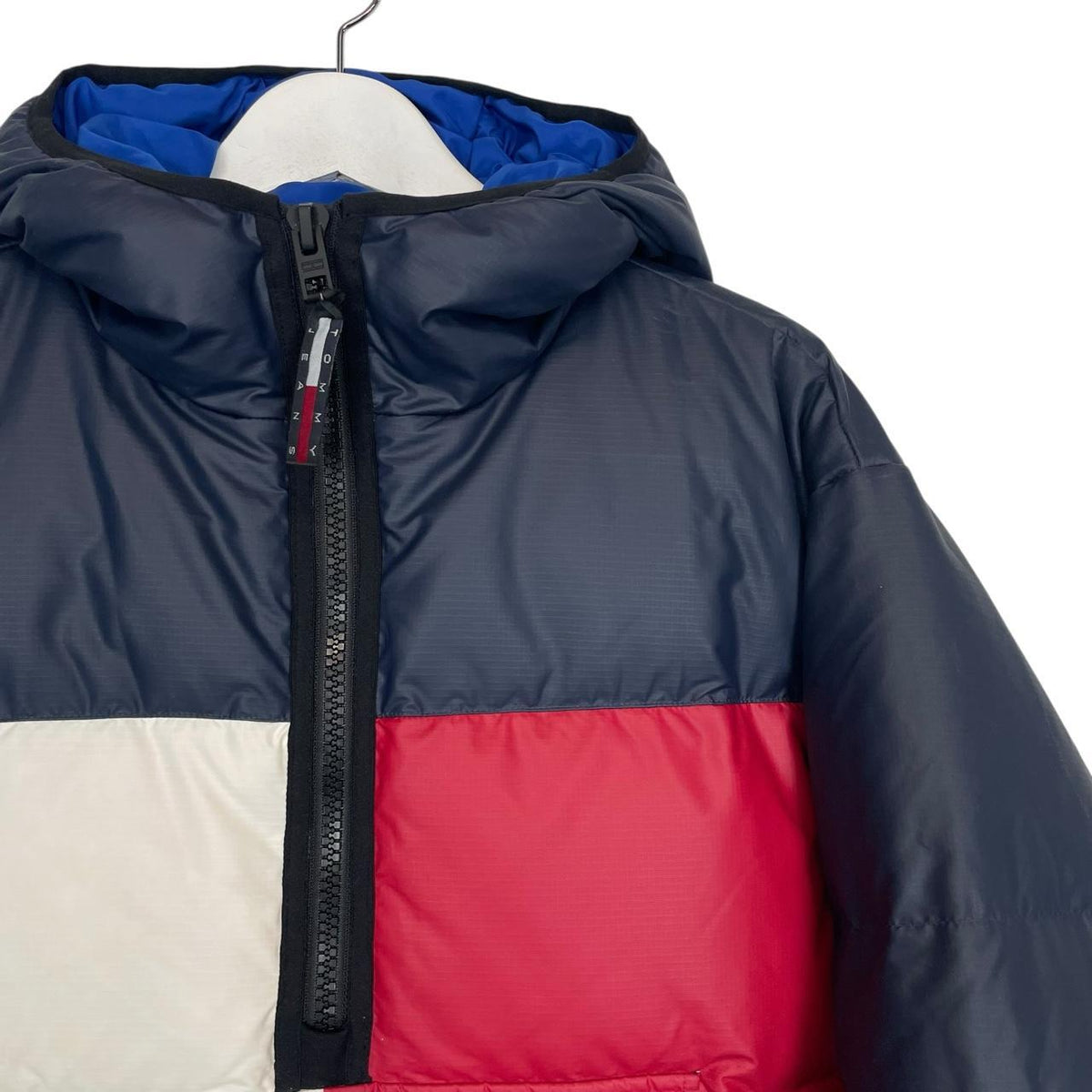 Tommy Hilfiger navy blue pullover jacket with 1/4 zip and hood, nylon material.