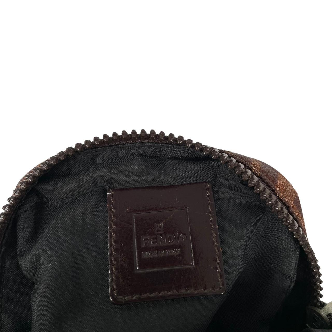 Fendi brown duffel bag with monogram canvas, visible wear and cracking on strap.