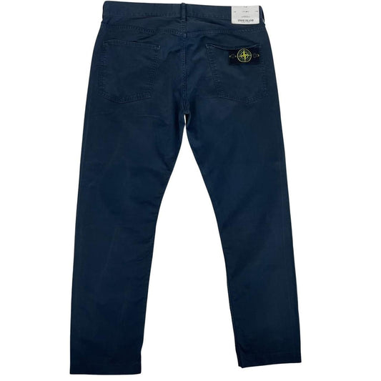 Stone Island navy blue trousers with RE-T fit, cotton material, and iconic compass logo.