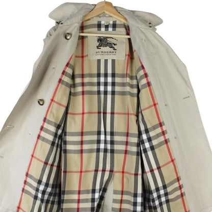 Burberry beige trench coat featuring Nova Check pattern and double-breasted design with belt.