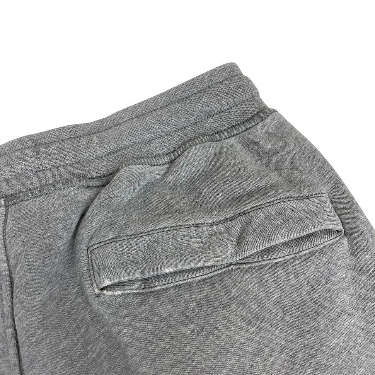 Stone Island grey joggers with logo patch and cotton material, size small.