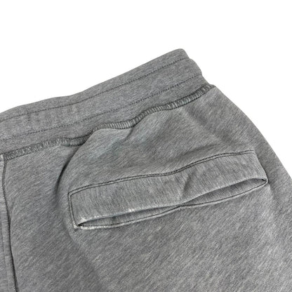 Stone Island grey joggers with logo patch and cotton material, size small.