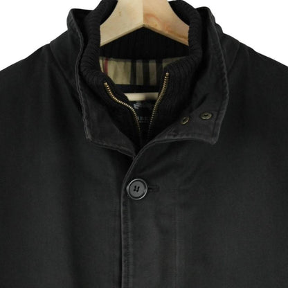 Burberry black coat with Nova Check lining and full zip closure, vintage style.