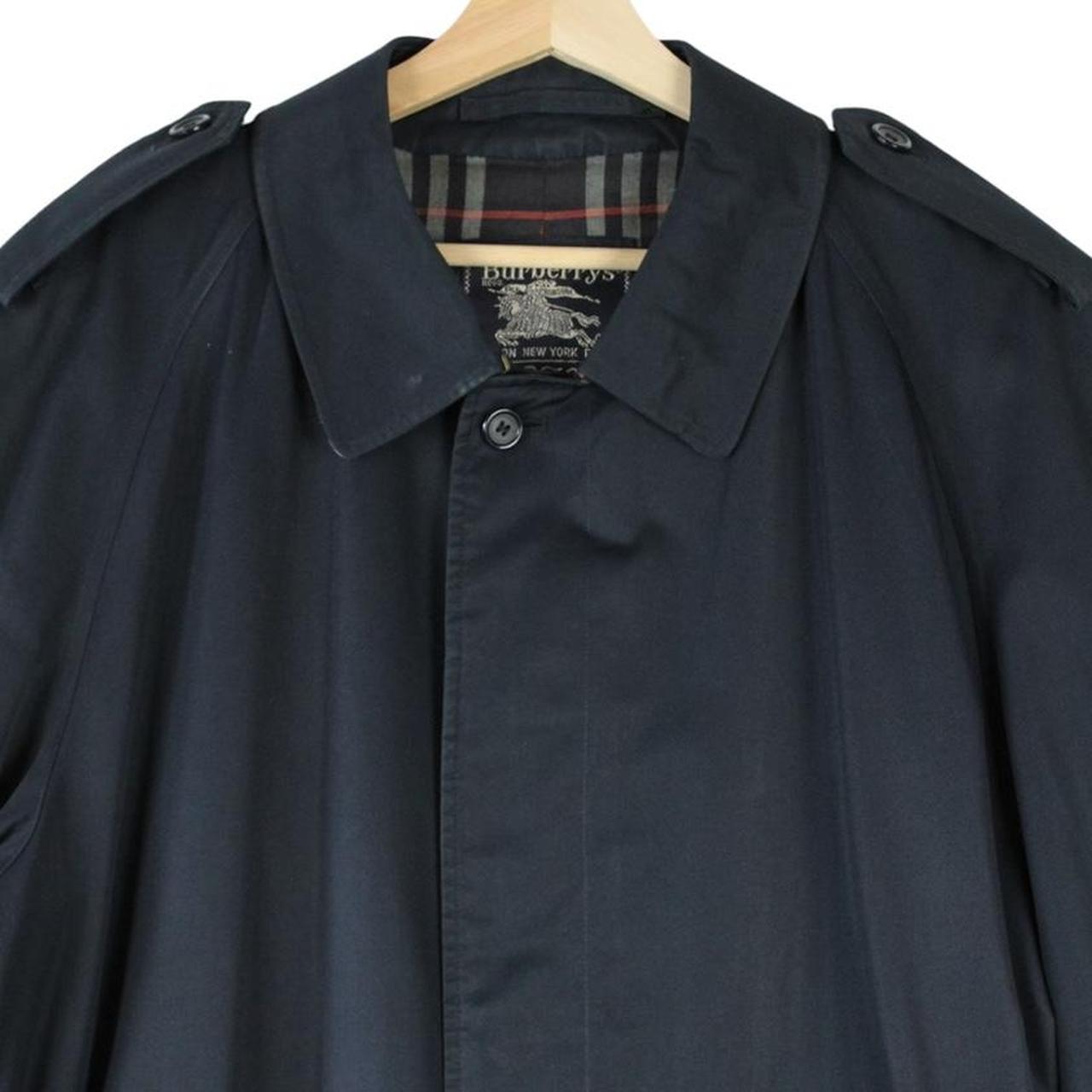 Burberry navy blue trench coat with belted waist and single breasted design.