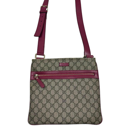 Gucci beige and pink duffel bag with GG Supreme monogram canvas pattern.