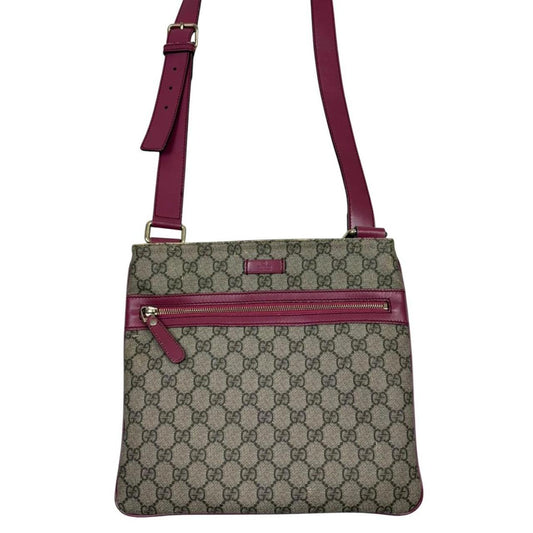 Gucci beige and pink duffel bag with GG Supreme monogram canvas pattern.