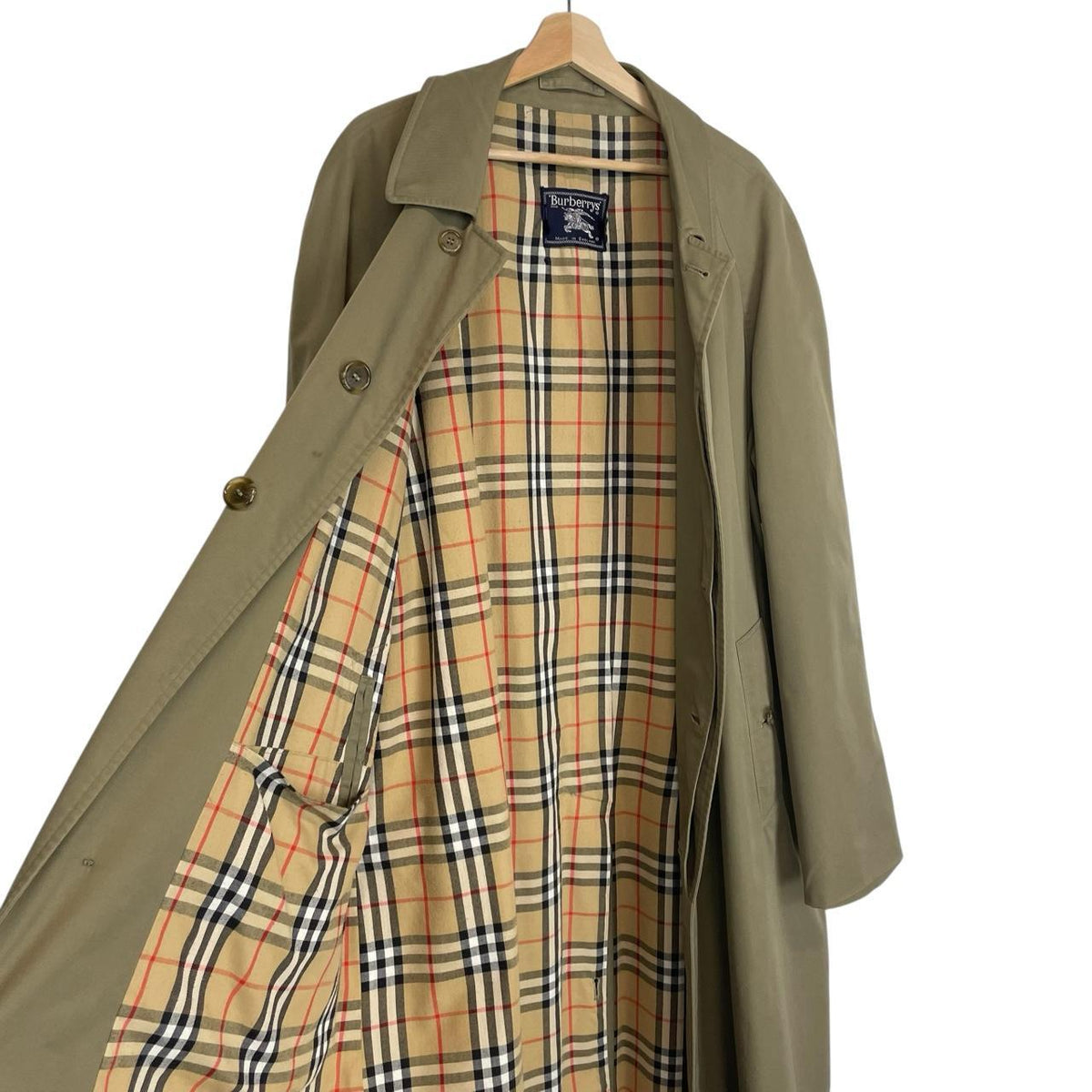Burberry khaki green trench coat featuring classic Nova Check pattern and single breasted design.