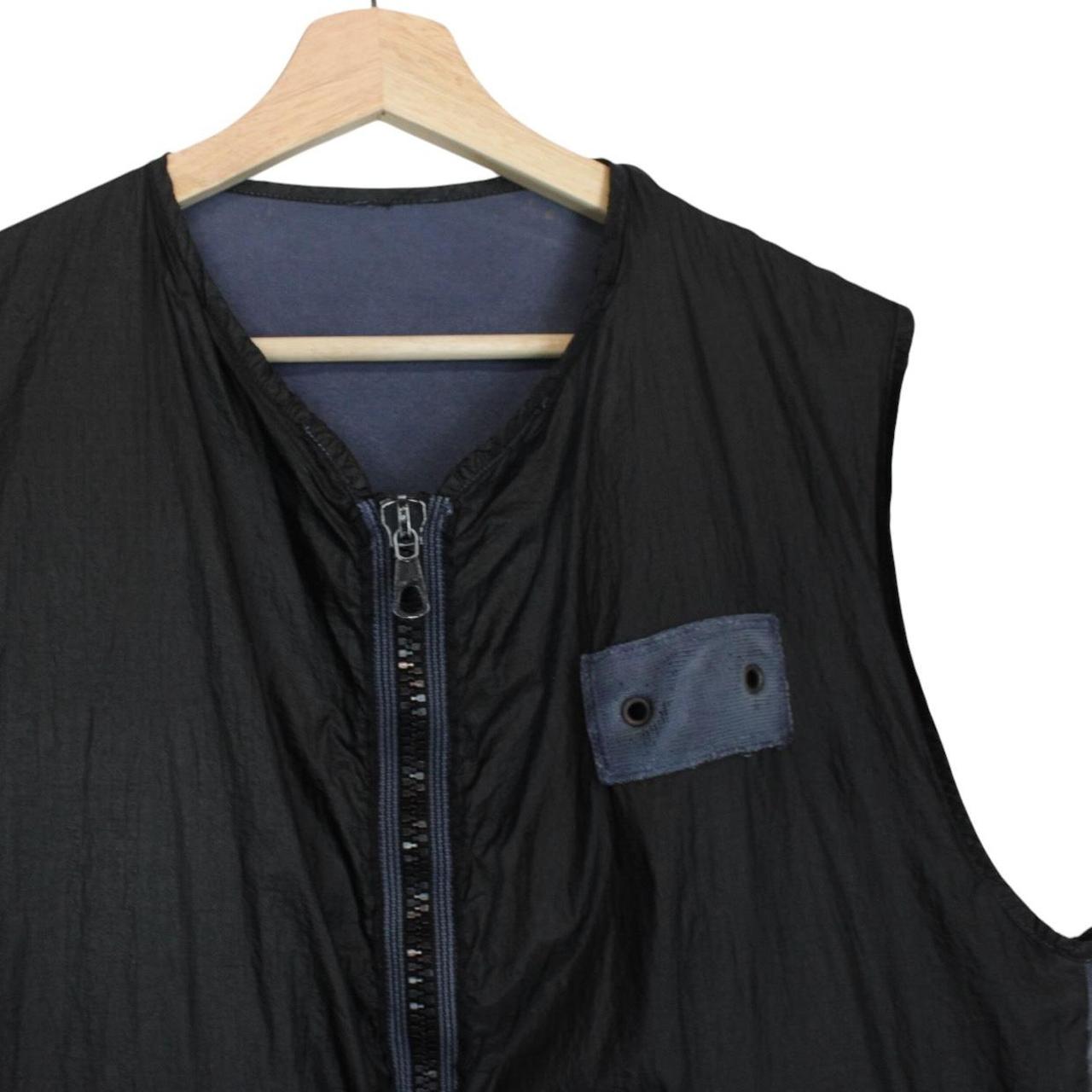 Stone Island navy blue reversible vest with green edge and logo patch detail.
