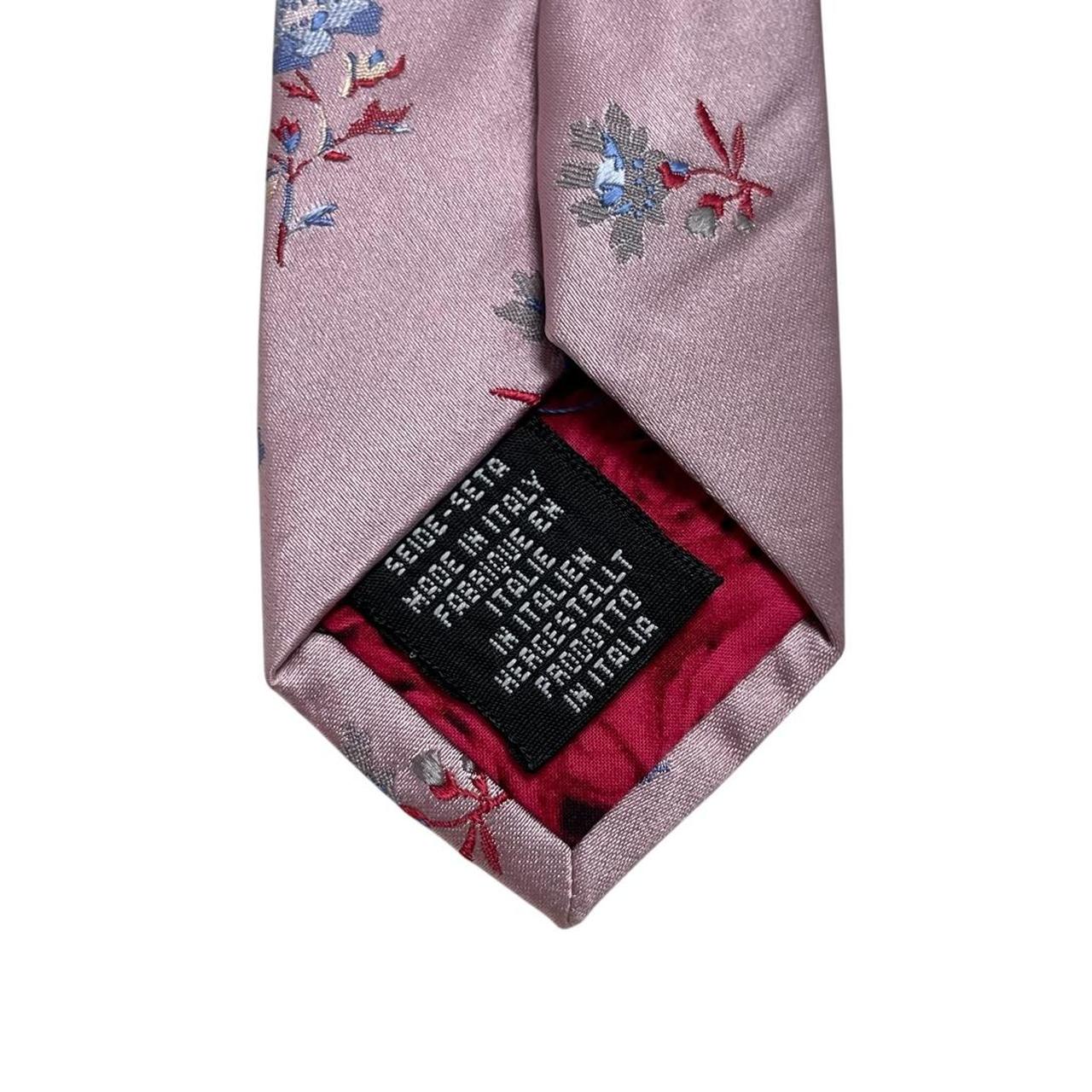 Paul Smith pink silk tie with floral embroidery and signature logo detail.