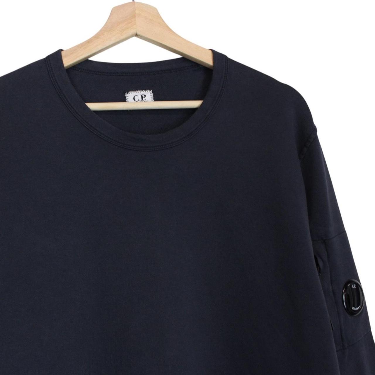CP Company navy blue cotton sweatshirt with goggle lens detail and logo.