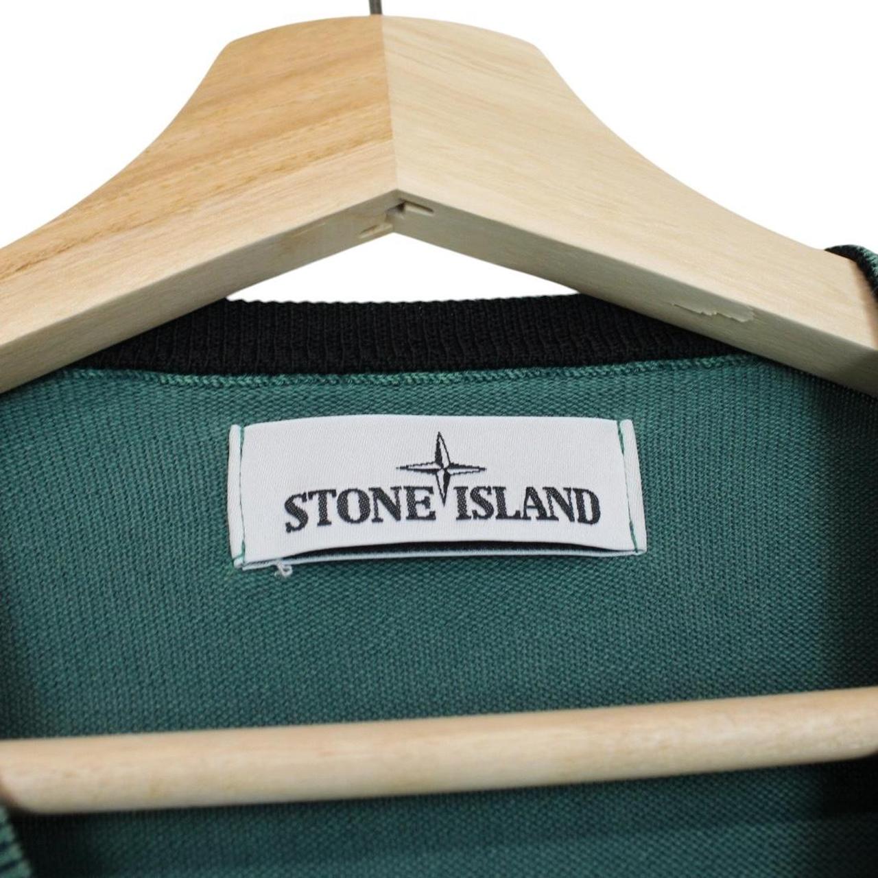 Stone Island green knit v-neck jumper with logo patch on sleeve and ribbed cuffs.