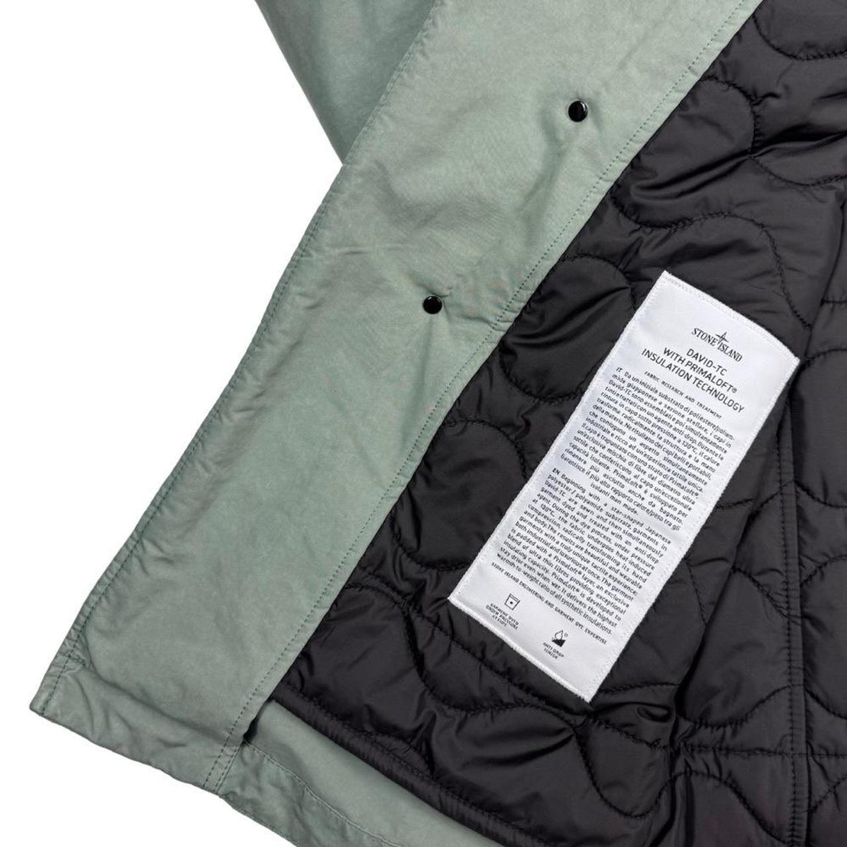 Stone Island green jacket with Primaloft insulation and iconic compass logo.