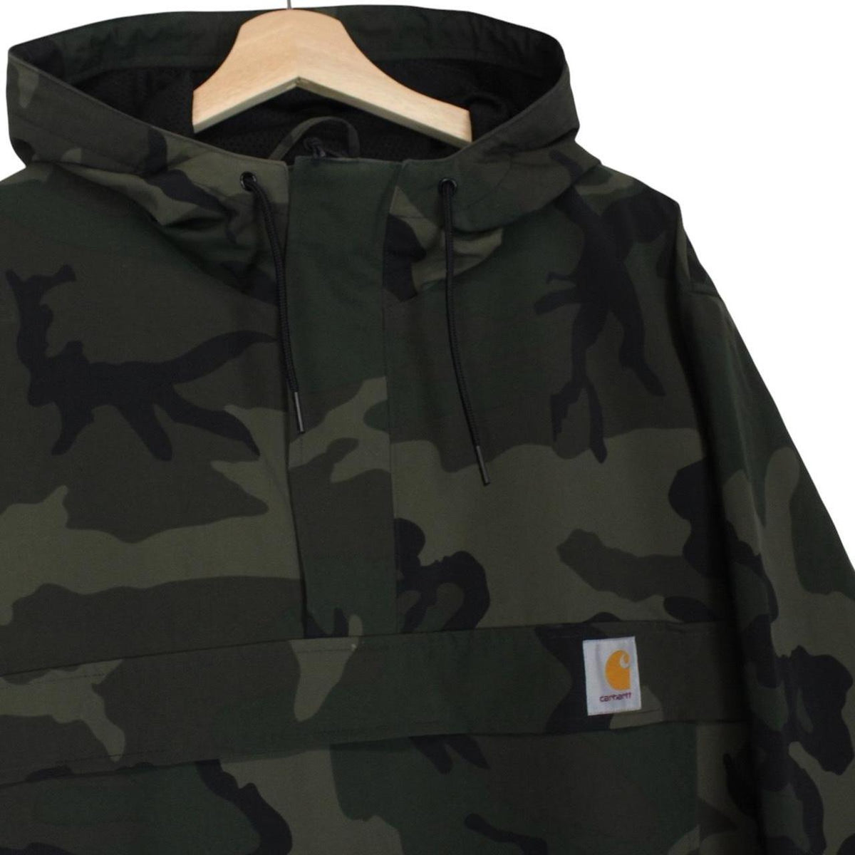 Carhartt camouflage hooded pullover jacket with logo and durable material.