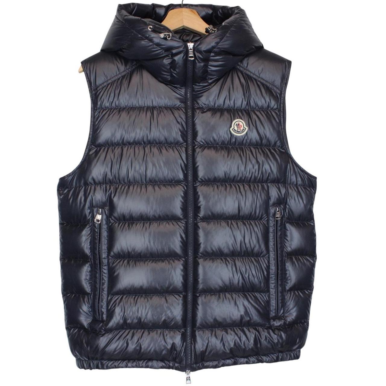 Moncler navy blue hooded nylon down gilet with logo and quilted texture.