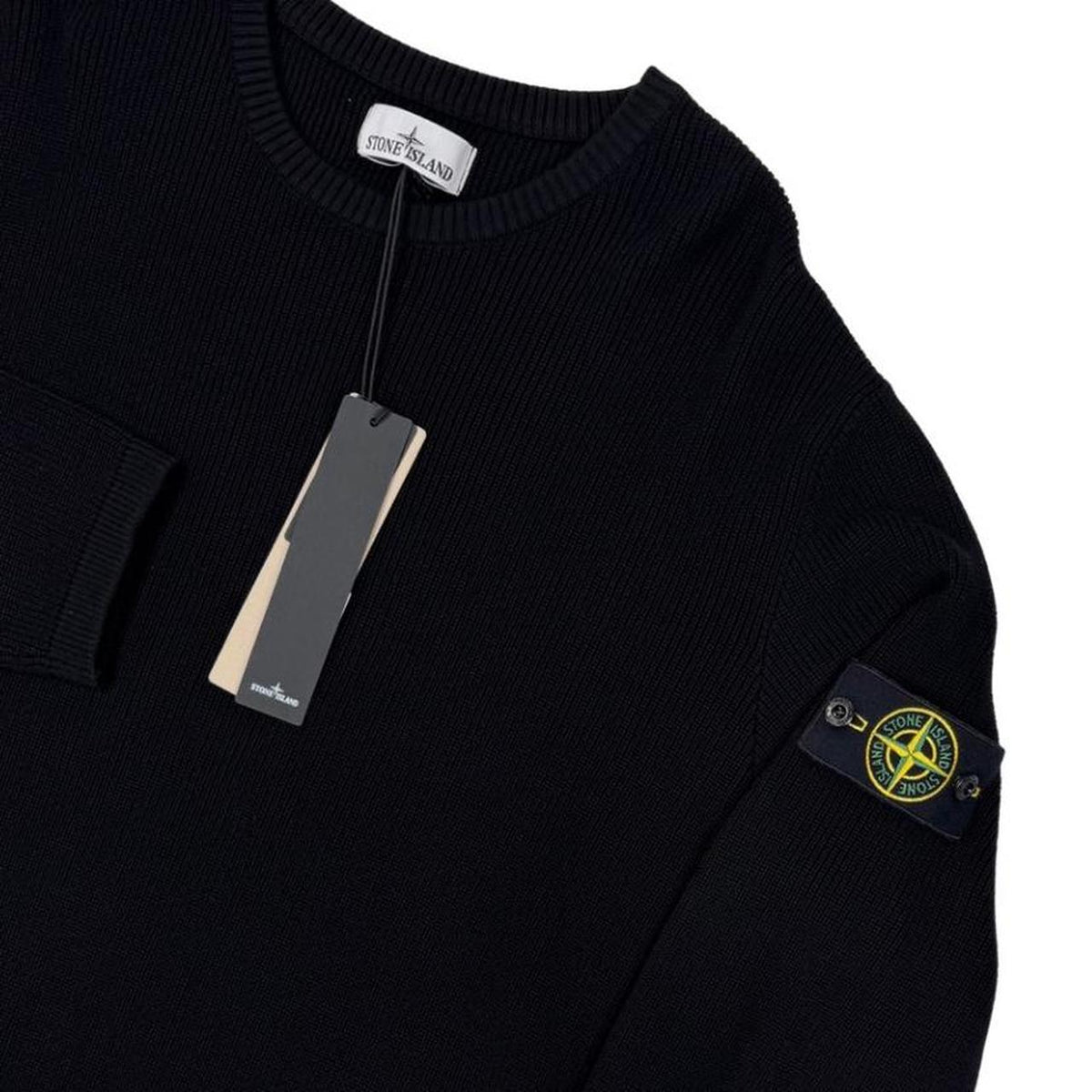 Stone Island black ribbed knit jumper with logo badge and organic cotton material.