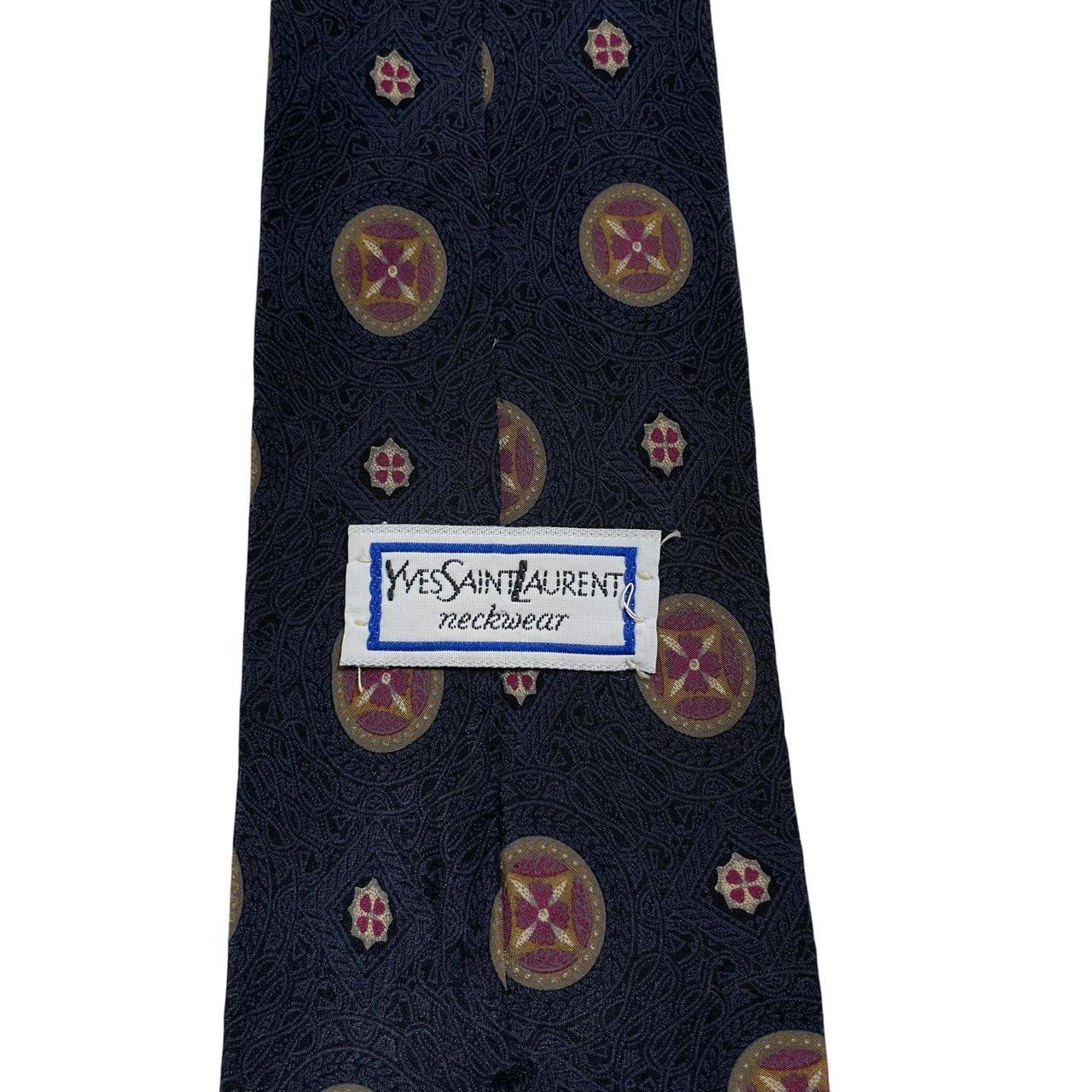 Yves Saint Laurent navy blue silk tie with abstract print design.