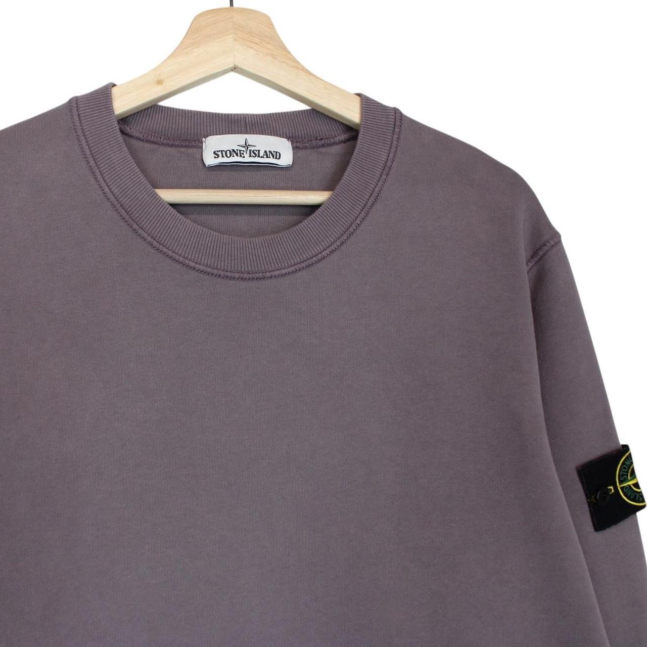 Stone Island pink sweatshirt with logo patch and soft cotton material.