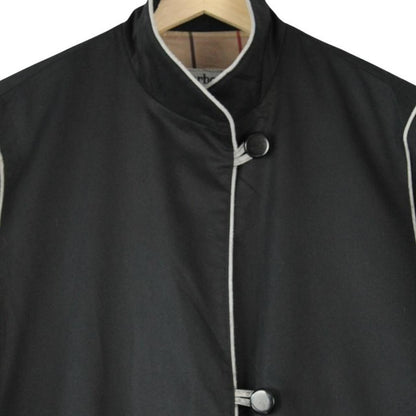 Burberry black cotton trench coat with single breasted design and classic logo detailing.