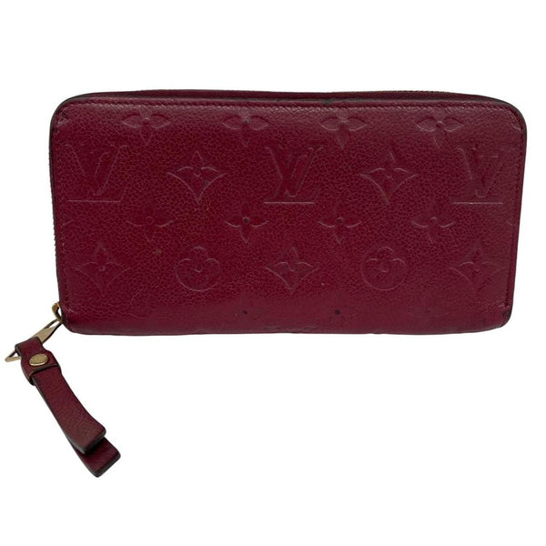 Louis Vuitton black leather wallet with monogram pattern and embossed logo.