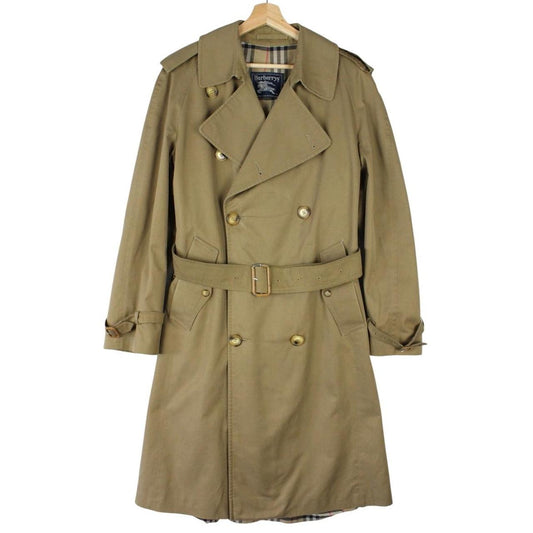 Burberry brown double breasted belted trench coat with classic check lining and logo details.