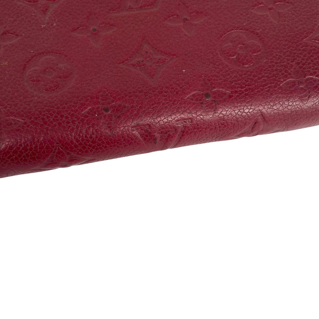 Louis Vuitton black leather wallet with monogram pattern and embossed logo.