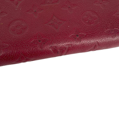 Louis Vuitton black leather wallet with monogram pattern and embossed logo.