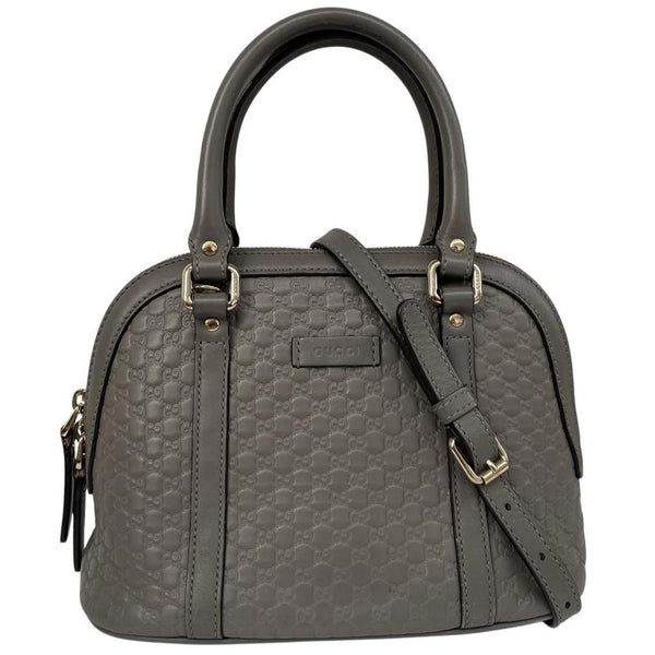Gucci grey microguccissima mini dome shoulder bag with embossed logo and leather material.