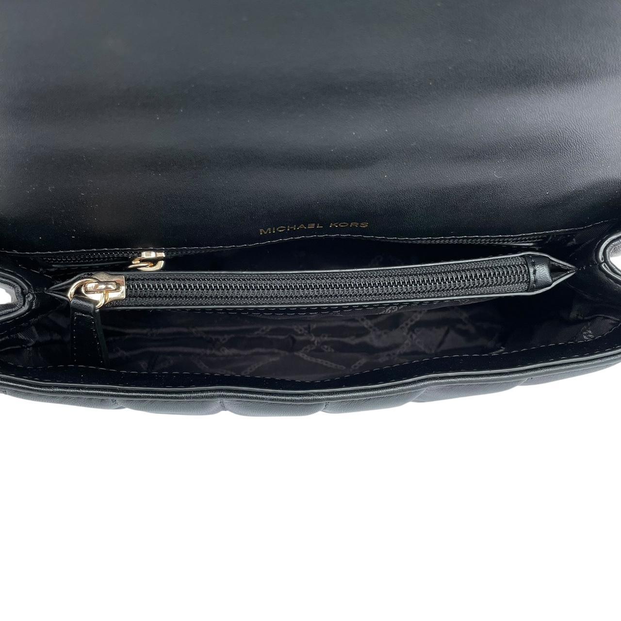 Michael Kors black duffel bag with quilted pattern and logo detail, pre-loved condition.